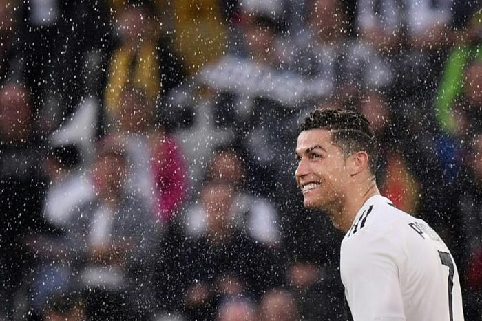 Cristiano Ronaldo looks on through drops of champagne after Juventus won an eighth straight Serie A title.