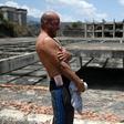 Venezuelan Erick Hurtado, with Bolivar bills equivalent to less than a US dollar tucked into his waistband, stands on the roof of Jehovah Gire, a half-done building in the Petare neighborhood of Caracas that is now home to dozens of squatters