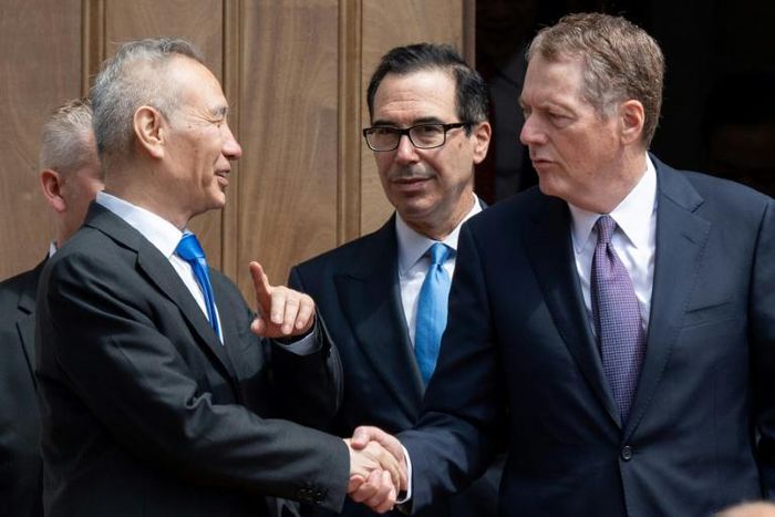 Chinese Vice Premier Liu He (L) shakes hands with US Trade Representative Robert Lighthizer (R) alongside US Treasury Secretary Steven Mnuchin (C) following two hours of negotiations