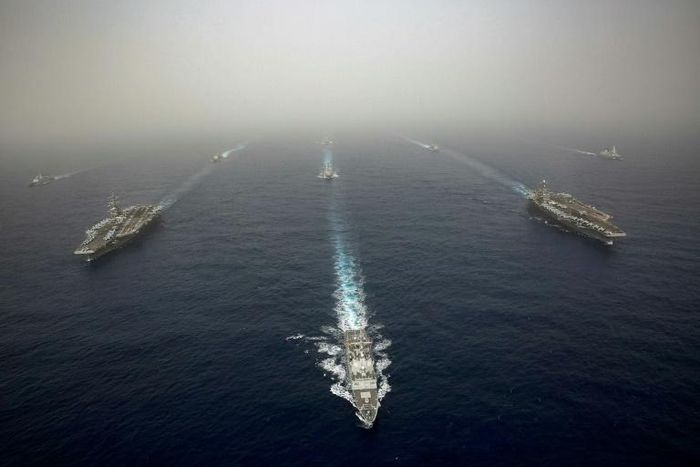 The US aircraft carrier USS Abraham Lincoln, on the left, sails in formation in the Mediterranean alongside British, French, Spanish and other US battleships on April 24, 2019 in this image released by the US Navy