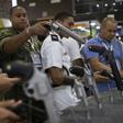 Visitors inspect guns during a security and defense expo in Rio de Janeiro, Brazil, on April 02, 2019