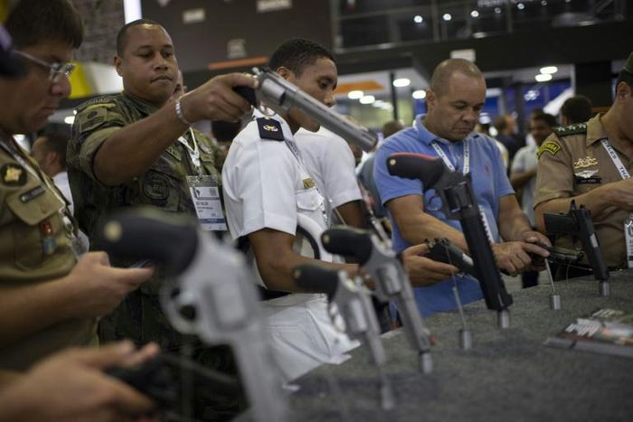 Visitors inspect guns during a security and defense expo in Rio de Janeiro, Brazil, on April 02, 2019