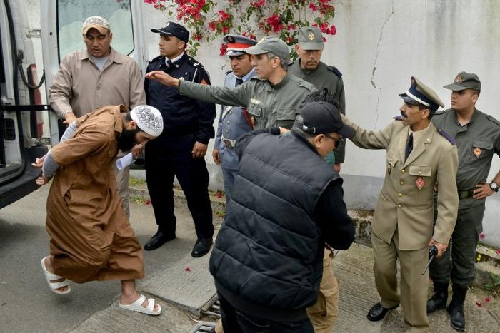 Suspects, charged in connection with the murder of two Scandinavian hikers, arrive for their trial at a Moroccan court