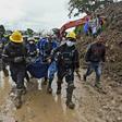 Firefighters carry away a dead body found under the mud in Rosas, southwest Colombia, following Sunday's mudslide provoked by heavy rains