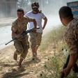 Fighters loyal to Libya's internationally recognised unity government run for cover during recent clashes with the self-styled Libyan National Army