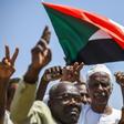 Sudanese protesters chant slogans, flash V-for-victory signs and wave the national flag at the sit-in outside the army headquarters in the capital Khartoum on May 14, 2019