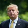 US President Donald Trump walks across the South Lawn of the White House after returning from Japan