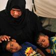 Salima, a 36-year-old mother of four living in the Laylan 2 displacement camp, sits with her children in their tent at the camp, southeast of Kirkuk in northern Iraq