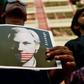 For many, "freedom of speech is unconditional," as the placard says, and that includes for WikiLeaks founder Julian Assange