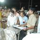 Gujarat Chief Minister Vijaybhai Rupani stands near the bodies of students who died in the fire in Surat