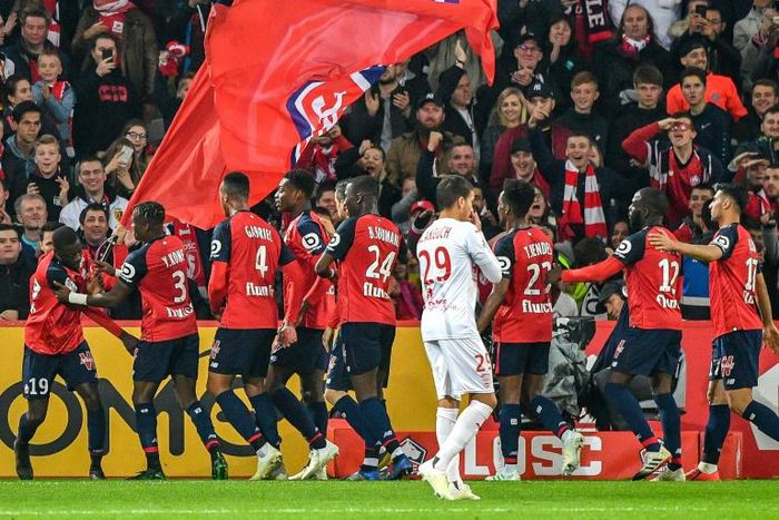 Lille players celebrate after Nicolas Pepe got his 20th goal of the season last weekend - they are second in Ligue 1 before Sunday's game at Lyon