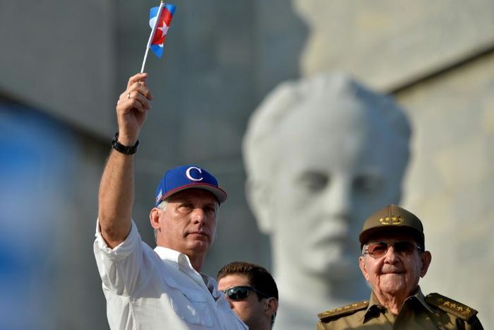 Miguel Diaz-Canel's (L) first year as president of Cuba has been anything but straightforward