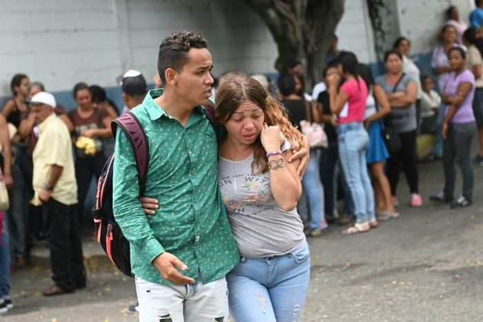 Families of prisoners who died in a riot in a police station jail wait in front of a morgue in Acarigua, Venezuela on May 25, 2019