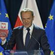 EU Council President Donald Tusk held up a copy of the Polish constitution during his speech