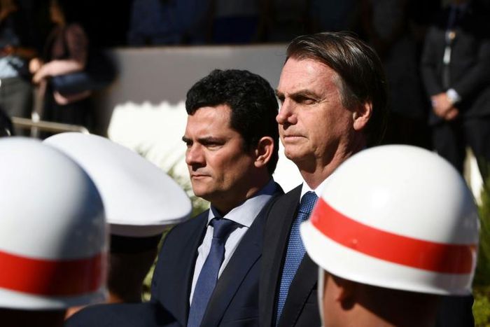 Brazilian President Jair Bolsonaro (R) and his Justice Minister Sergio Moro, who is under fire over accusations he acted improperly as a judge in a sprawling corruption case