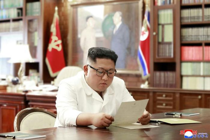 This undated and unlocated picture released from North Korea's official Korean Central News Agency (KCNA)on June 23, 2019 shows North Korean leader Kim Jong Un reading a personal letter from President of the United States of America Donald Trump.