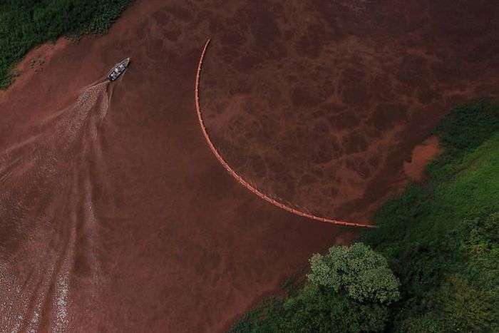 A boat sails the Paraopeba River in Brazil after the collapse of a dam at a mine belonging to Vale near Brumadinho