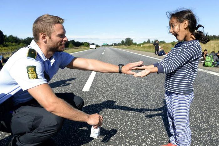 A Danish policeman plays with a migrant girl on the Danish-German border. With the exception of the far left, all of Denmark's political parties are now in agreement on keeping immigration at its current low