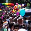Men and women in colourful costumes, including several dressed as samba dancers, paraded through the streets on motorised floats or sashayed alongside