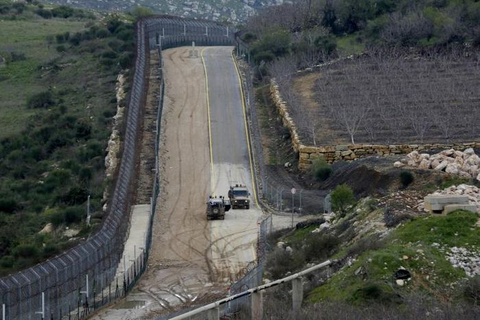 Israeli military vehicles patrol the border fence with Syria in the Israeli-annexed Golan Heights