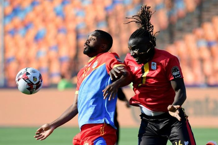 DR Congo's forward Cedric Bakambu (L) fights for the ball with Uganda's defender Hassan Wasswa during the 2019 Africa Cup of Nations (CAN) football match between DR Congo and Uganda at Cairo International Stadium on June 22, 2019.