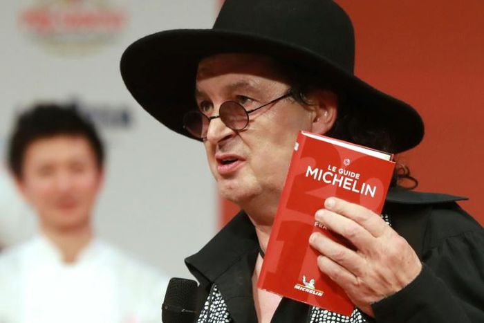 Happier days: French chef Marc Veyrat holds the Michelin guide in triumph when he won his third star for his La Maison des Bois restaurant in 2018