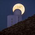 (FILES) In this file photo taken on December 13, 2016 the full moon is seen behind a telescope of the Spain's Institute of Astrophysics of the Canary Islands, in the National Park of El Teide, on the Spanish canary island of Tenerife on December. A tea...