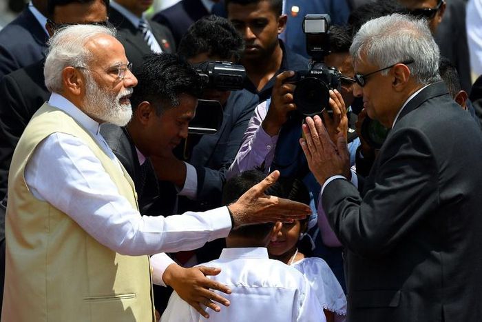 Sri Lankan Prime Minister Ranil Wickremesinghe (right) welcomes Indian Prime Minister Narendra Modi at Bandaranaike International Airport in Katunayake