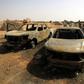 Damaged cars at the site of a bomb attack that targeted servicemen during the funeral of an ex-army commander in the Libyan city of Benghazi