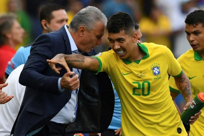 Coach Tite (left) celebrates with goalscorer Roberto Firmino in Brazil's 5-0 thumping of Peru