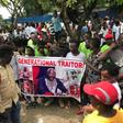 Demonstrators hold a poster portraying Liberian President George Weah as they gather outside the Liberian Mansion in Monrovia on June 7, 2019 during an anti-government march to protest inflation and corruption
