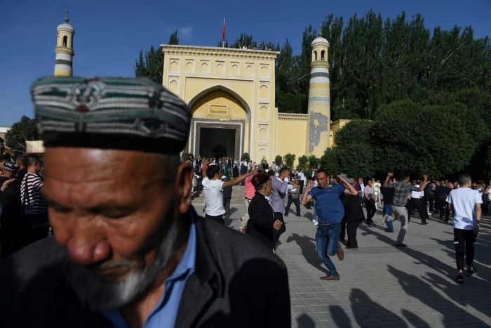 Uighur men dance after Eid al-Fitr prayers in Kashgar, in China's western Xinjiang region