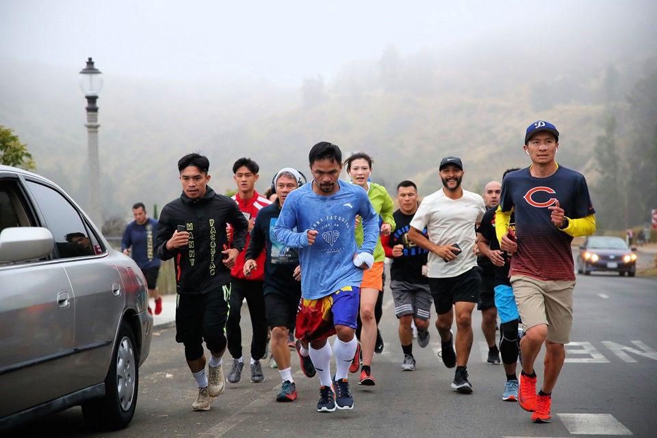 Pacquiao and crew mid-stride.