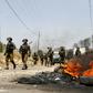 Israeli security forces take position during a weekly demonstration by Palestinians against the expropriation of their lands by Israel in the village of Kfar Qaddum, near Nablus in the occupied West Bank