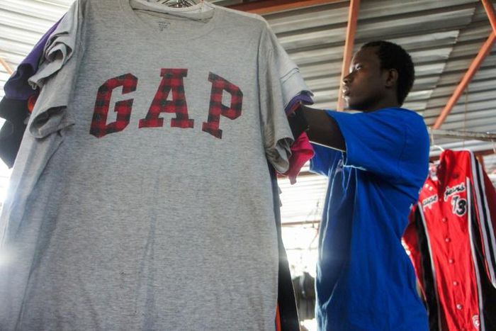 Mind the GAP: Mamadou Sarr prepares his stall at Colobane Market, the biggest trading arena for second-hand clothes in Dakar
