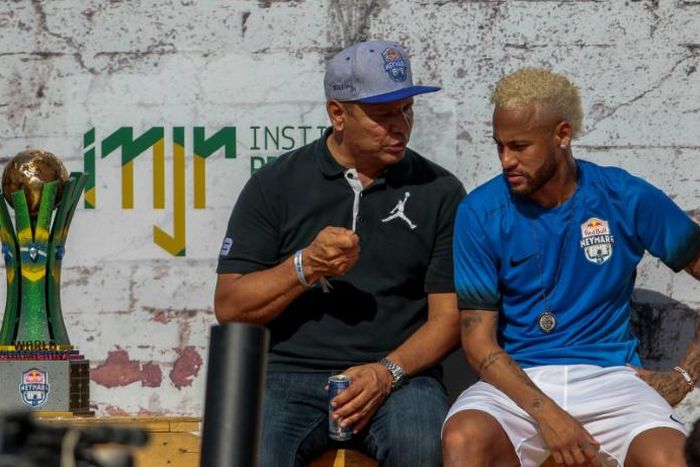 Neymar, pictured here with his father, is yet to return to Paris for pre-season training and on Saturday played in a five-a-side football tournament for his charity Neymar Junior Project Institute near Sao Paulo