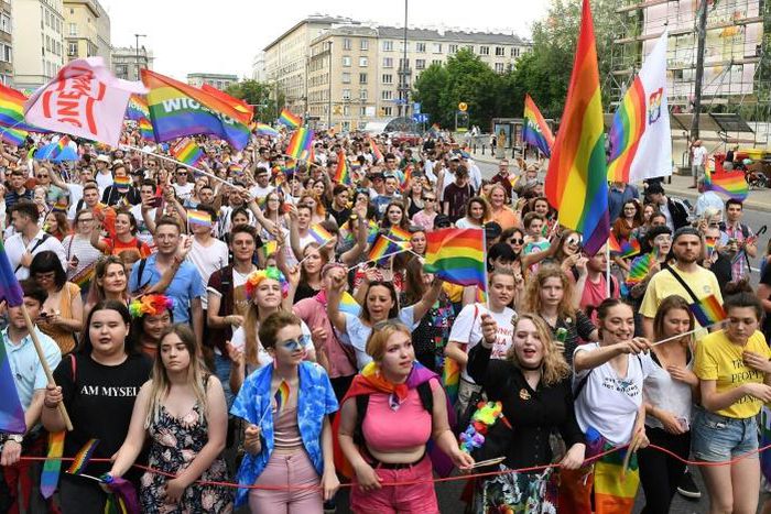 People wave rainbow flags during the Baltic gay pride parade on June 8, 2019 on the streets of the Polish capital Warsaw