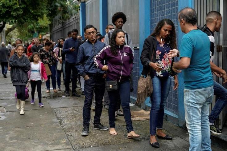 People queue in front of the Telecommunications Workers Union, where a weekly job fair takes place in Rio de Janeiro -- there are 13 million unemployed in Brazil