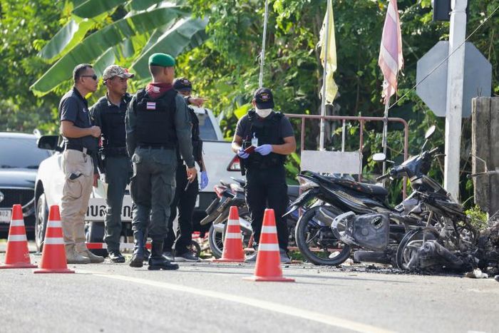 Police inspect the scene of a deadly attack by suspected rebels at a military outpost in Pattani, southern Thailand.