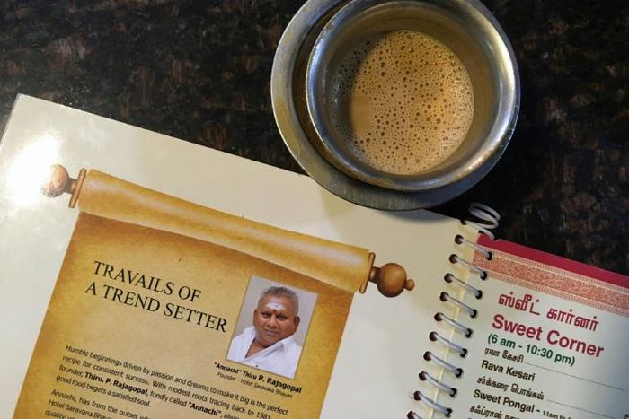 An image of "Dosa King" P. Rajagopal is printed on the menu at one of his restaurants in Chennai, India