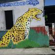 A woman walks by a mural in Ciudad Hidalgo, Chiapas State, Mexico, on June 6, 2019