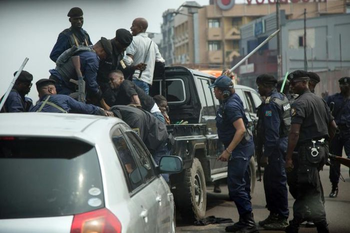 Police officers clash with protesters during a Kinshasa rally to mark the 59th anniversary of DR Congo's independence