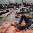 (FILES) In this file photo taken on June 17, 2017 illegal immigrants are seen sleeping at a detention centre in Zawiyah, 45 kilometres west of the Libyan capital Tripoli. The heads of two refugee agencies have called for refugees and migrants held in L...