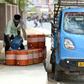 An man fills containers with water on a roadside in Churu, Rajasthan, which is sweltering under a heatwave