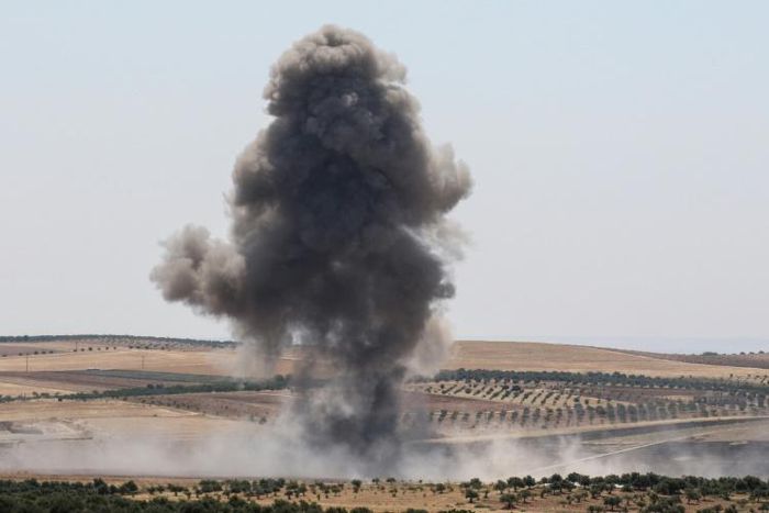 Smoke billows after reported regime air strikes near Khan Sheikhun in Syria's Idlib province