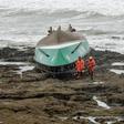 After capsizing, it ended up upside down on the rocky shore