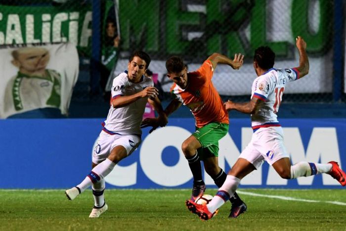 Argentina Banfield forward Julian Carranza, in center battling two defenders from Uruguay's Nacional, was among the first two players signed Friday by David Beckham's MLS expansion club Inter Miami, which takes the field in 2020