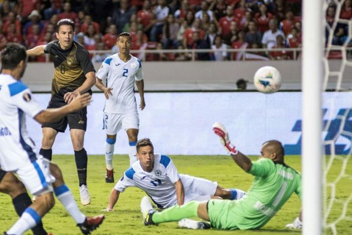 Costa Rica's Bryan Oviedo, in the dark jersey, scores a goal against Nicaragua in Sunday's Gold Cup match