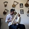 Egyptian craftsman Mohamed Ghaly adds the finishing touches on a semsemia that he made at the Canal 20 cultural museum in Port Said which he founded to pass on the musical heritage to a new generation