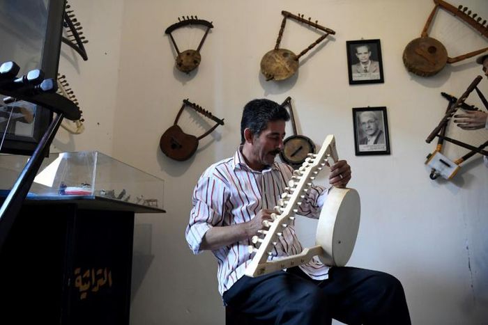 Egyptian craftsman Mohamed Ghaly adds the finishing touches on a semsemia that he made at the Canal 20 cultural museum in Port Said which he founded to pass on the musical heritage to a new generation